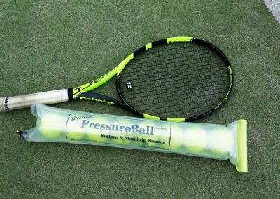 tennis racket and pressureball tube
